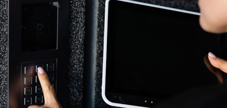 a woman setting up a burglar alarm for business usage